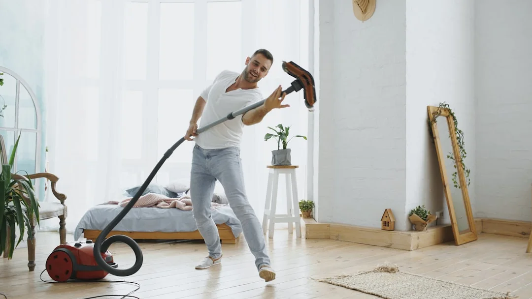 services-02 Cleaner using a vacuum in a stylish indoor setting, showcasing cleaning equipment and techniques.